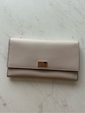 kate spade taupe blush leather flap wallet with gold plaque